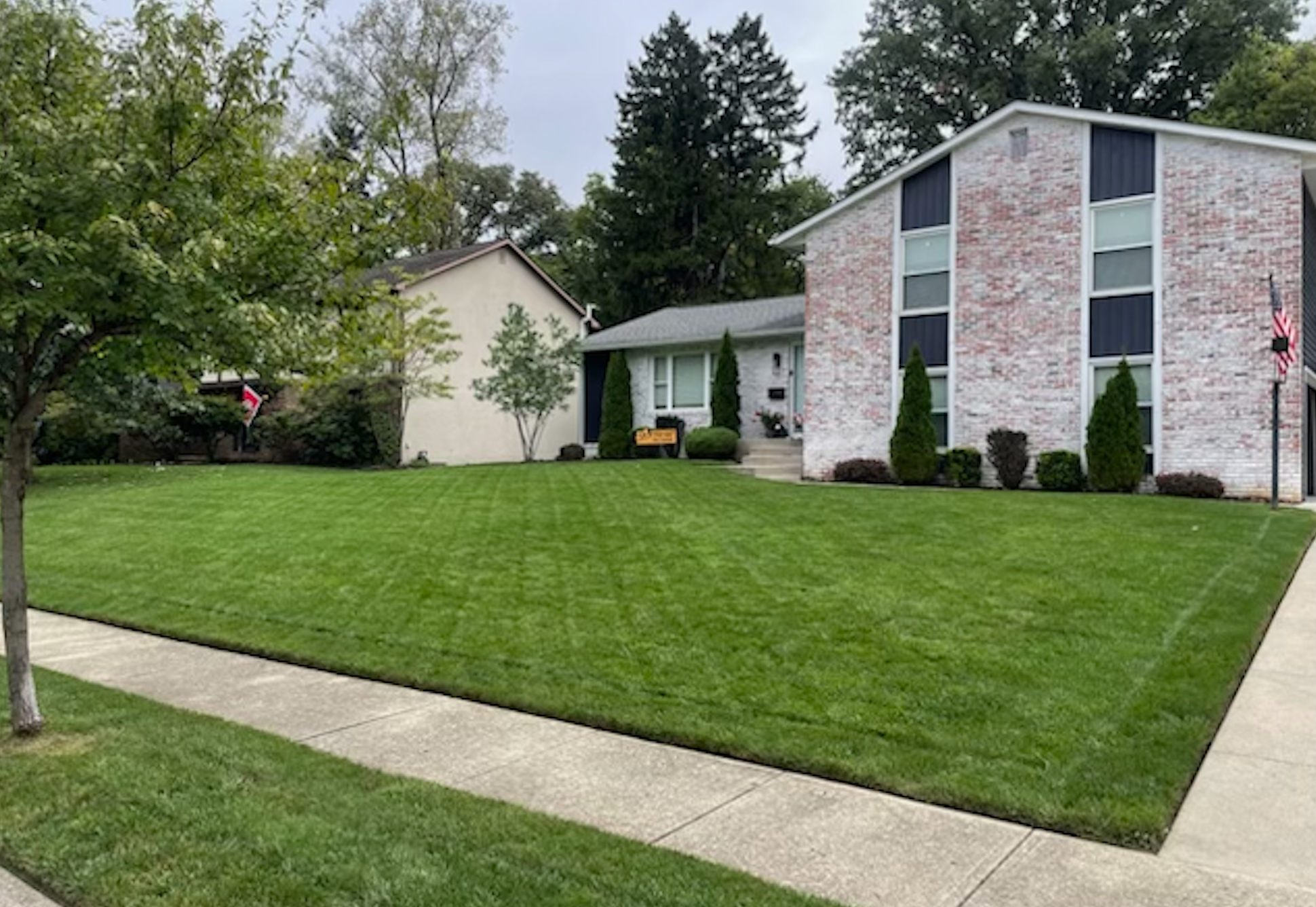 Clean mowing stripes on a residential yard — lawn care service in Columbus area